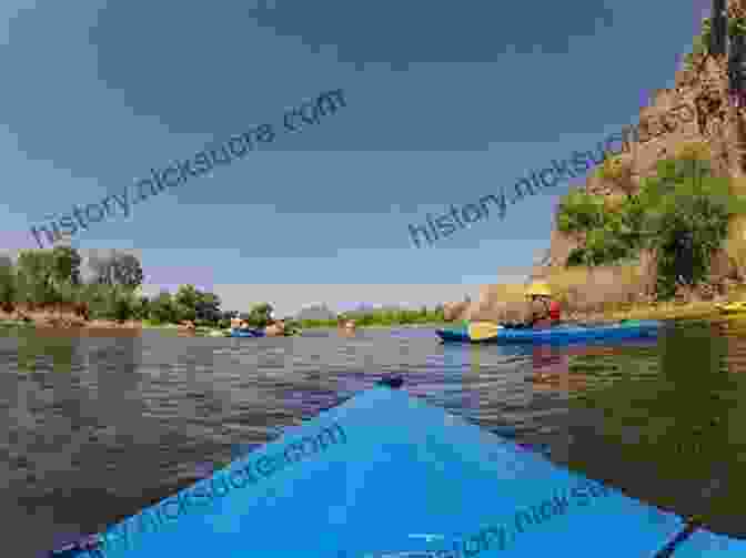 A Group Of Kayakers Paddling Down The Salt River In Arizona, With The Superstition Mountains In The Background. The Complete Guide To Kayaking The Salt River: Everything You Need To Know To Paddle The Lower Salt River