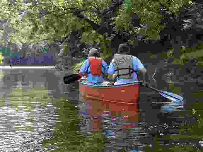 Canoeists Paddling On The Serene Tar River, Surrounded By Lush Foliage And The Tranquil Sounds Of Nature Down The Wild Cape Fear: A River Journey Through The Heart Of North Carolina